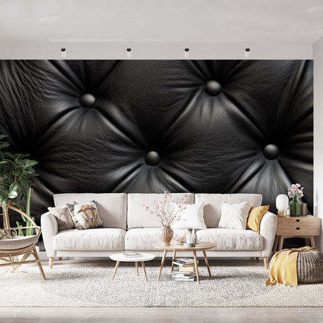 Black leather tufted wallpaper creating luxurious atmosphere in modern living room with grey sofa and pendant lighting