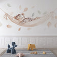 Baby Leopard Wallpaper creating a peaceful nursery atmosphere, shown in a bright modern children's room with natural decor