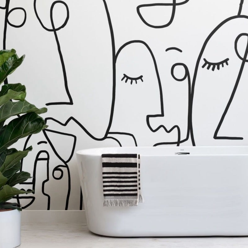 Line art face wallpaper creating a striking focal point in a minimal Scandinavian living room