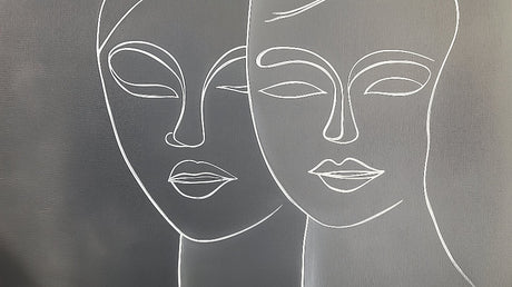 Line art face wallpaper creating a modern statement wall in a minimalist living room with grey sofa and natural light