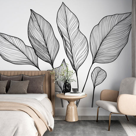 Black and white botanical line art wallpaper creating a modern accent wall in a bright, minimalist living room setting