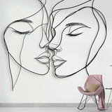 Line art face wallpaper creating a modern statement wall in a minimalist living room with natural lighting
