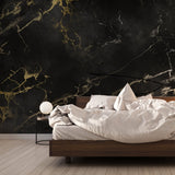 Black and gold marble wallpaper in modern dining room with crystal chandelier and golden accents