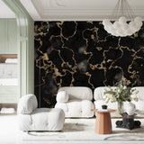 Master bedroom with striking black and gold marble accent wall