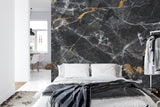 Luxury marble wall mural transforming a master bathroom with gold fixtures
