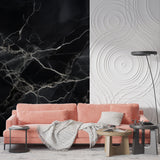 Elegant dining room featuring black and white marble wall mural with crystal chandelier