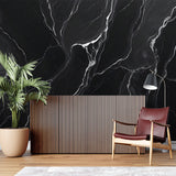 Black marble wallpaper creating dramatic impact in modern living room with white furniture
