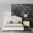 Dark grey marble wallpaper creating drama in a modern living room with clean furniture lines