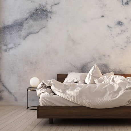 Marble wallpaper creates a stunning accent wall in a modern living room with grey furniture
