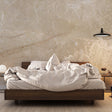 Beige marble wallpaper adding luxury to a modern living room with soft lighting and minimal furniture