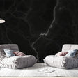 Black marble wallpaper with white veins creating a dramatic effect in a modern living room with high ceilings