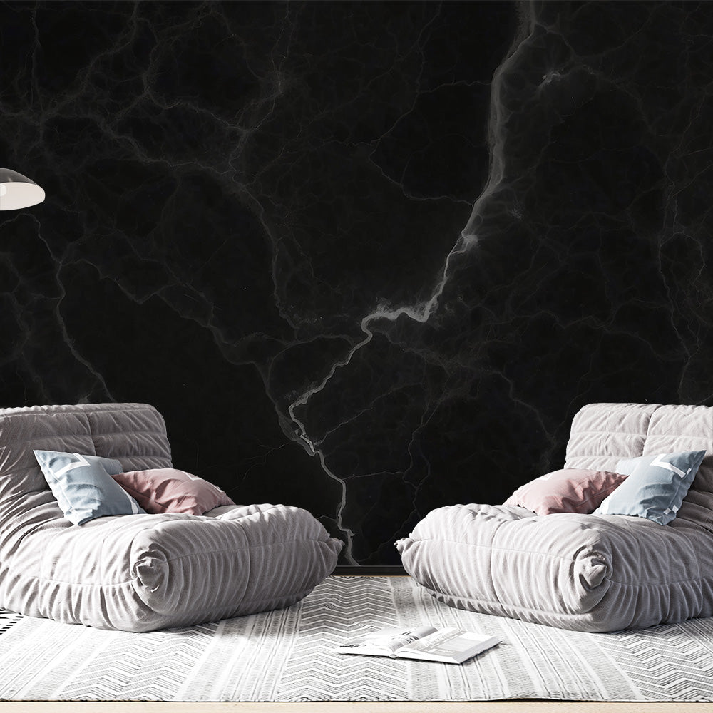 Black marble wallpaper with white veins creating a dramatic effect in a modern living room with high ceilings