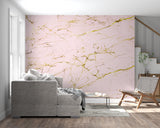 Pink and gold marble wallpaper in modern living room with natural light highlighting the metallic accents