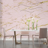 Elegant dining room featuring pink marble wall mural with soft gold veining