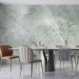 Green marble wallpaper creating luxury atmosphere in modern living room with natural light