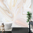 Pink and gold marble wallpaper creating an elegant backdrop in a modern living room with clean furniture