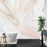 Pink and gold marble wallpaper creating an elegant backdrop in a modern living room with clean furniture