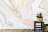 Abstract marble wall mural bringing warmth to a bedroom with gold accents