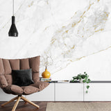 White and gold marble wallpaper creating luxury atmosphere in modern living room with natural light