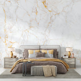 Marble wall mural with gold veining in master bedroom adding luxury feel