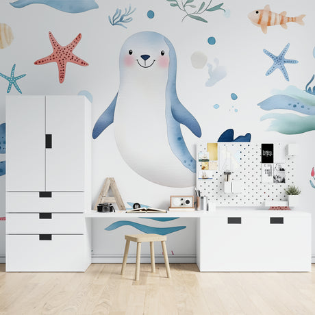 Marine animals wallpaper in bright nursery with white furniture showing playful seal and starfish design
