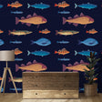 Marine life wallpaper transforms a modern kids bedroom with swimming fish patterns on deep navy background