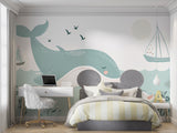 Whale wall mural displayed in a coastal-themed children's bedroom with blue accents
