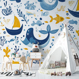 Ocean theme wallpaper in a kids bedroom with blue accents and nautical decor
