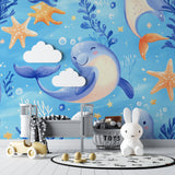 Marine animals wallpaper creating a magical underwater scene in a modern nursery with white furniture