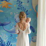Whale and starfish wallpaper transforming a playroom into an underwater paradise
