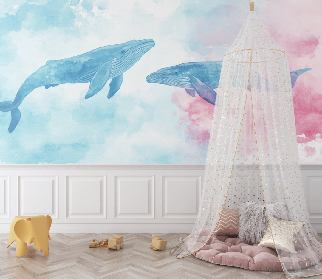Marine animals wallpaper displayed in a bright nursery, showing watercolor whales floating across pastel walls