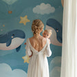 Marine animals wallpaper in a modern nursery with rocking chair and mobile