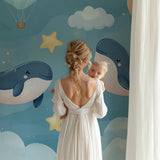 Marine animals wallpaper in a modern nursery with rocking chair and mobile