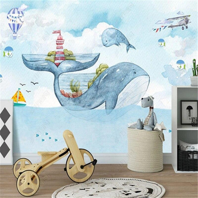 Marine whale wallpaper mural styled in a cozy nursery with wooden furniture and soft lighting