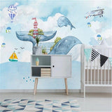 Whale and lighthouse wallpaper creating a dreamy atmosphere in a kids reading nook