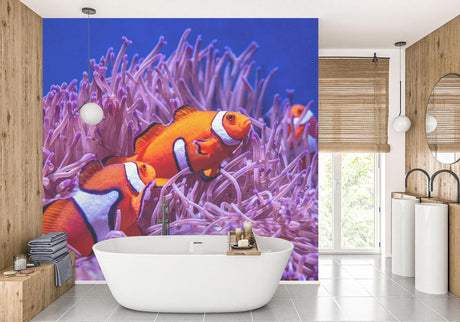 Marine life wallpaper featuring orange clownfish and purple anemone in modern living room setting