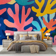 Coral reef abstract wallpaper bringing vibrant ocean colors to a modern living room with white furniture