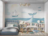 Marine theme wall mural showcasing a gentle whale and sailboat in a baby room