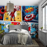 Bedroom with superhero-themed wall art and a gray bed.