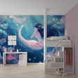 Mermaid wallpaper creating magic in a girl's bedroom with soft lighting and floating bubbles