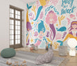 Mermaid wall mural bringing magic to a cozy children's bedroom with soft lighting