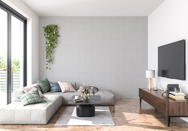 Modern grey minimalist wallpaper in bright living room with contemporary furniture