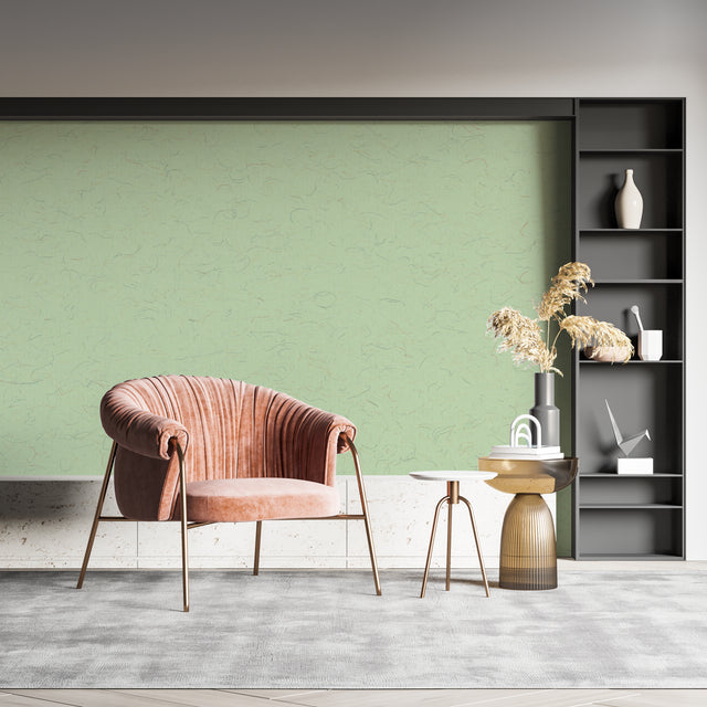 Sage green textured wallpaper in modern living room setting creating a calm, sophisticated atmosphere