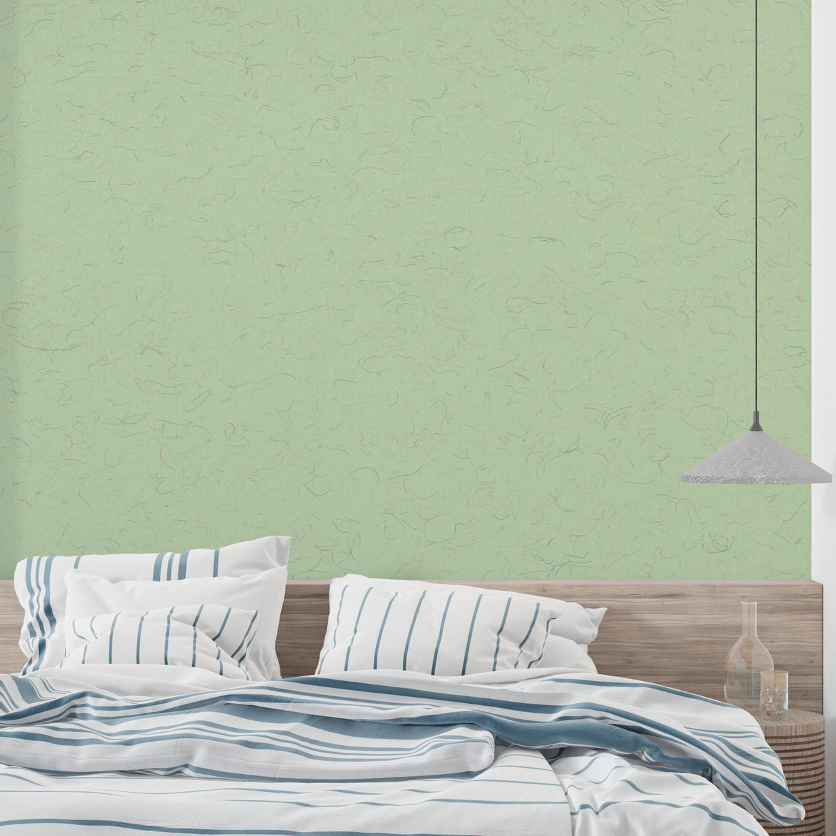 Textured sage wallpaper in home office setting highlighting the subtle pattern details