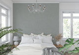 Sage grey textured wall mural in minimalist bedroom creating calm atmosphere