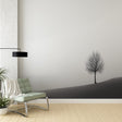 Minimalist tree wallpaper creating a serene atmosphere in a modern living room with clean lines and minimal furniture