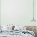 Soft green wallpaper in home office showing clean minimal aesthetic