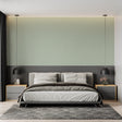 Sage green textured wallpaper in a modern living room with natural light streaming through windows