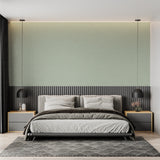 Sage green textured wallpaper in a modern living room with natural light streaming through windows
