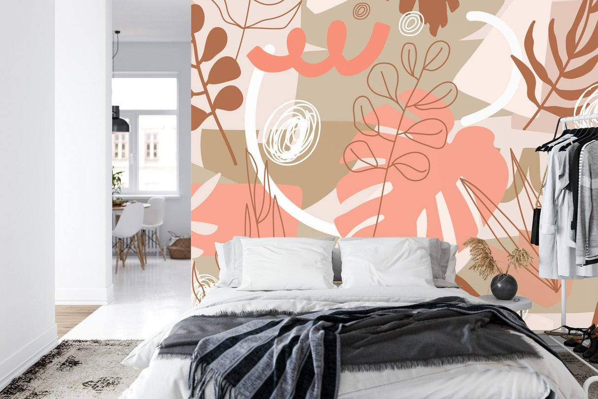Home office space with contemporary Monstera leaf wall mural in warm coral tones